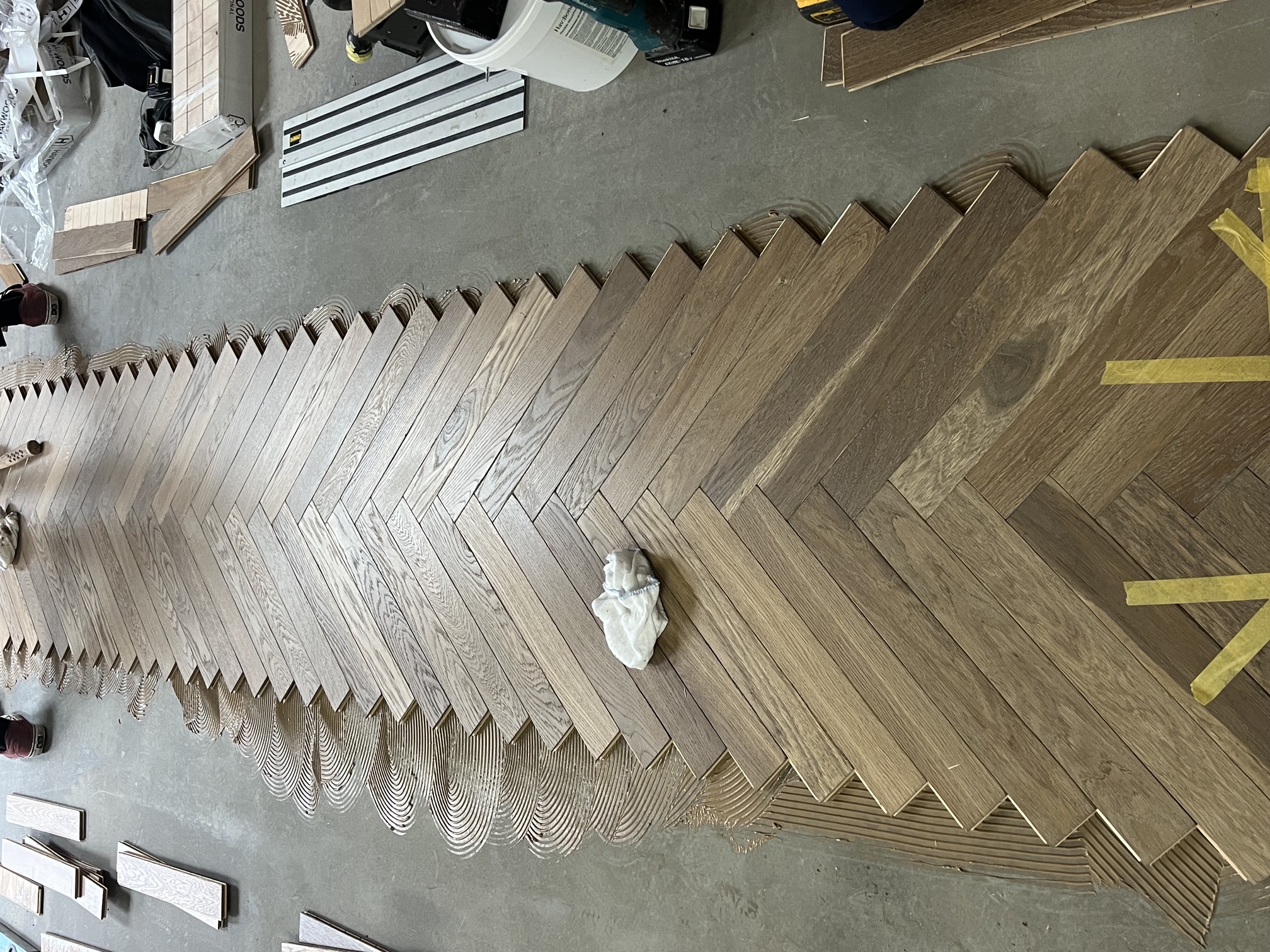 Engineered oak herringbone flooring being installed in South West London
